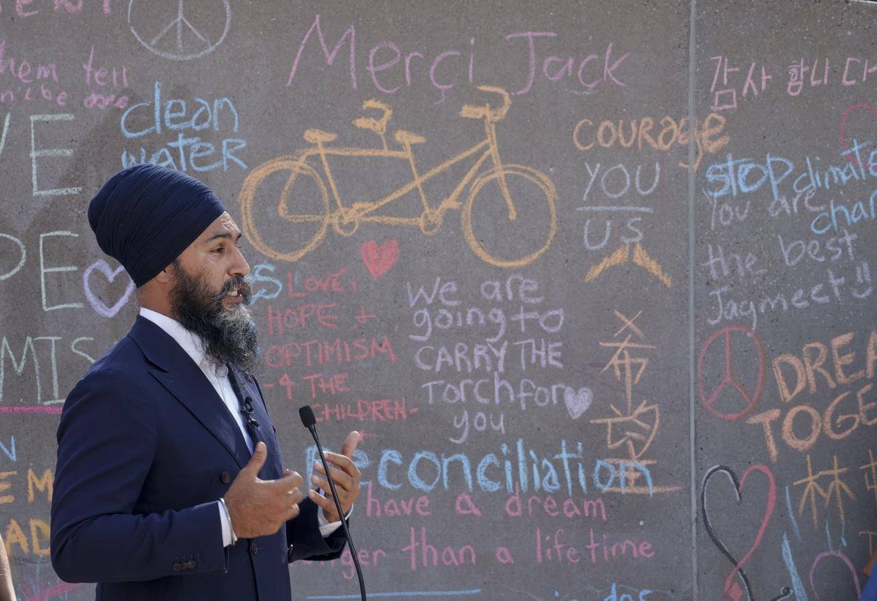 NDP Leader Jagmeet Singh responds to questions in front of a Jack Layton memorial wall in Toronto on Sunday, August 22, 2021. THE CANADIAN PRESS/Paul Chiasson