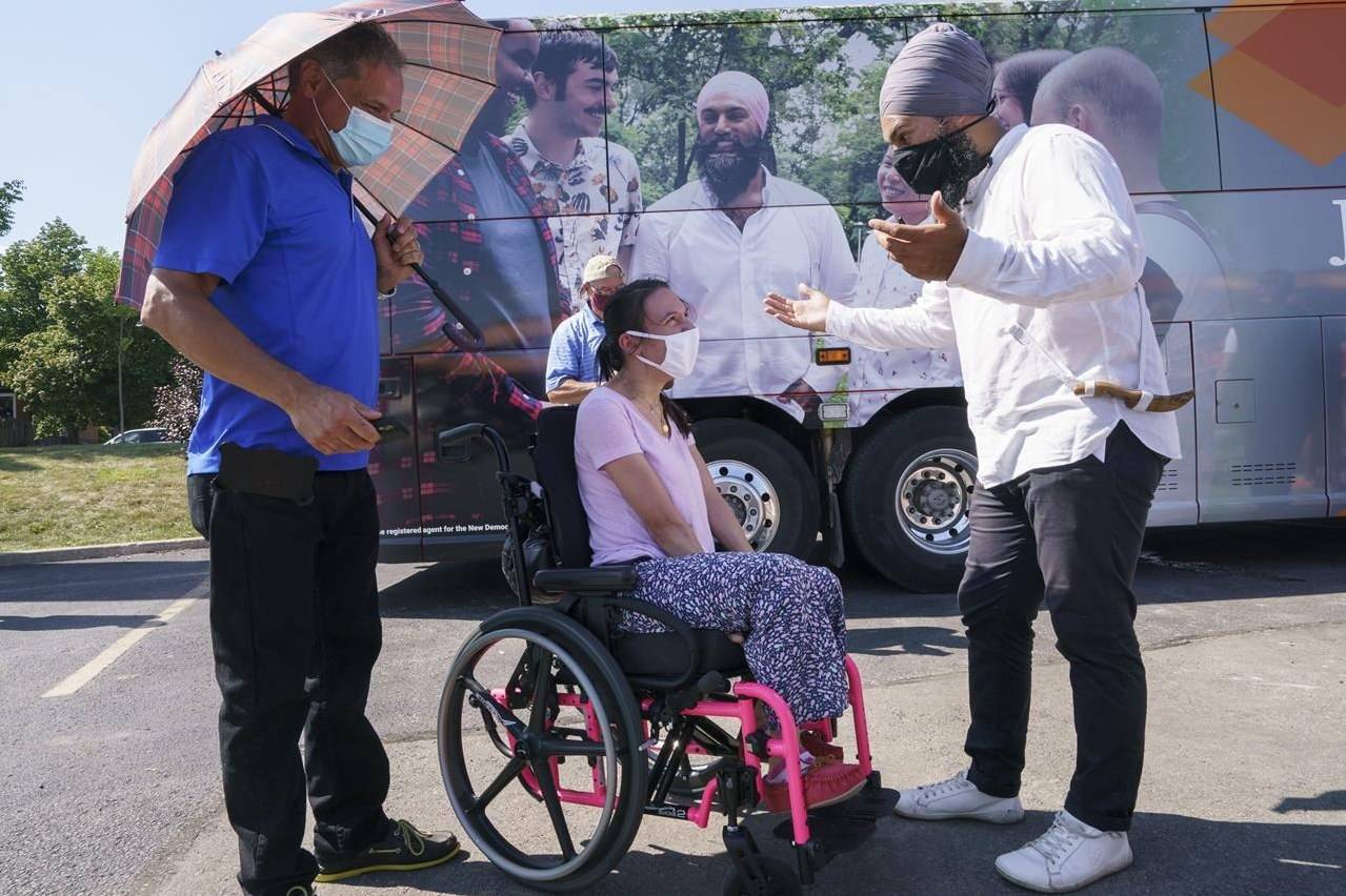 NDP leader Jagmeet Singh talks with a supporter during a campaign stop in Hamilton, Ont., on Tuesday, August 24, 2021. THE CANADIAN PRESS/Paul Chiasson