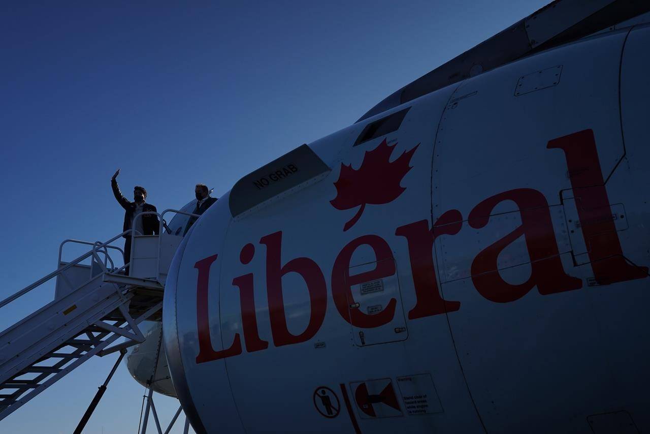 Liberal Leader Justin Trudeau waves from the steps of his campaign plane as he arrives in Iqaluit, Nunavut on Monday, August 30, 2021. THE CANADIAN PRESS/Nathan Denette