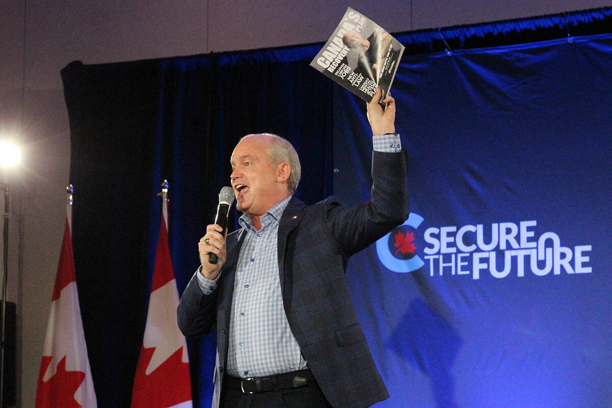 Conservative Party of Canada leader Erin O’Toole holds up his party’s platform while addressing supporters Saturday, Sept. 4, at the Vancouver Island Conference Centre in Nanaimo. (Greg Sakaki/News Bulletin)