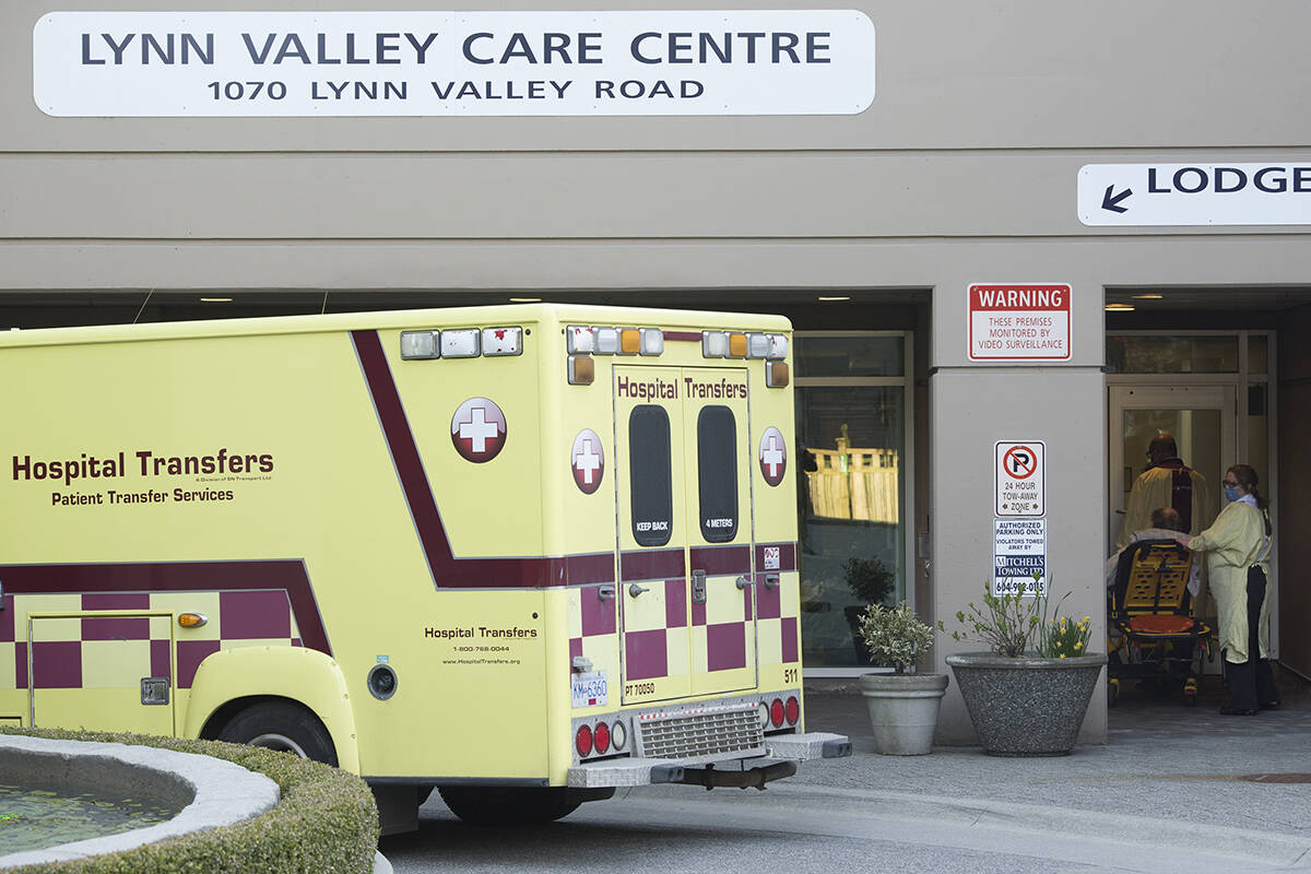 Hospital transfer workers are seen outside the Lynn Valley Centre care home in North Vancouver, B.C. Wednesday, April 8, 2020. THE CANADIAN PRESS/Jonathan Hayward