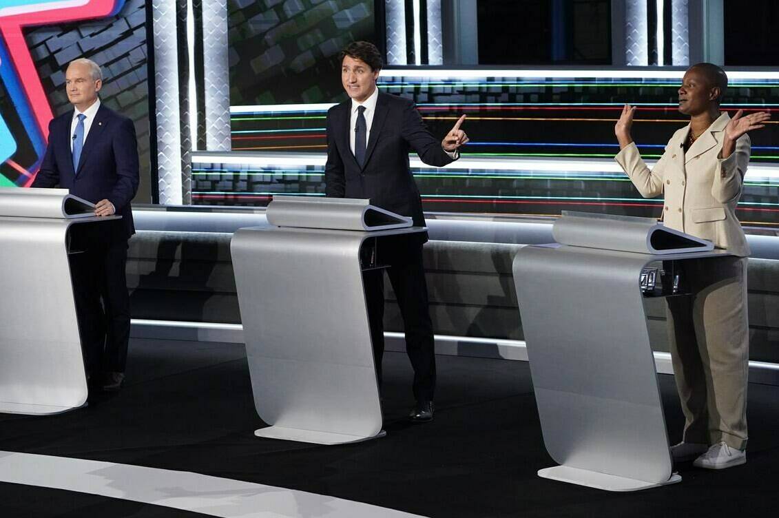 Conservative leader Erin O’Toole listens as Liberal leader Justin Trudeau and Green leader Annamie Paul discuss a point during the federal election French-language leaders debate, Wednesday, September 8, 2021 in Gatineau, Que. THE CANADIAN PRESS/Sean Kilpatrick