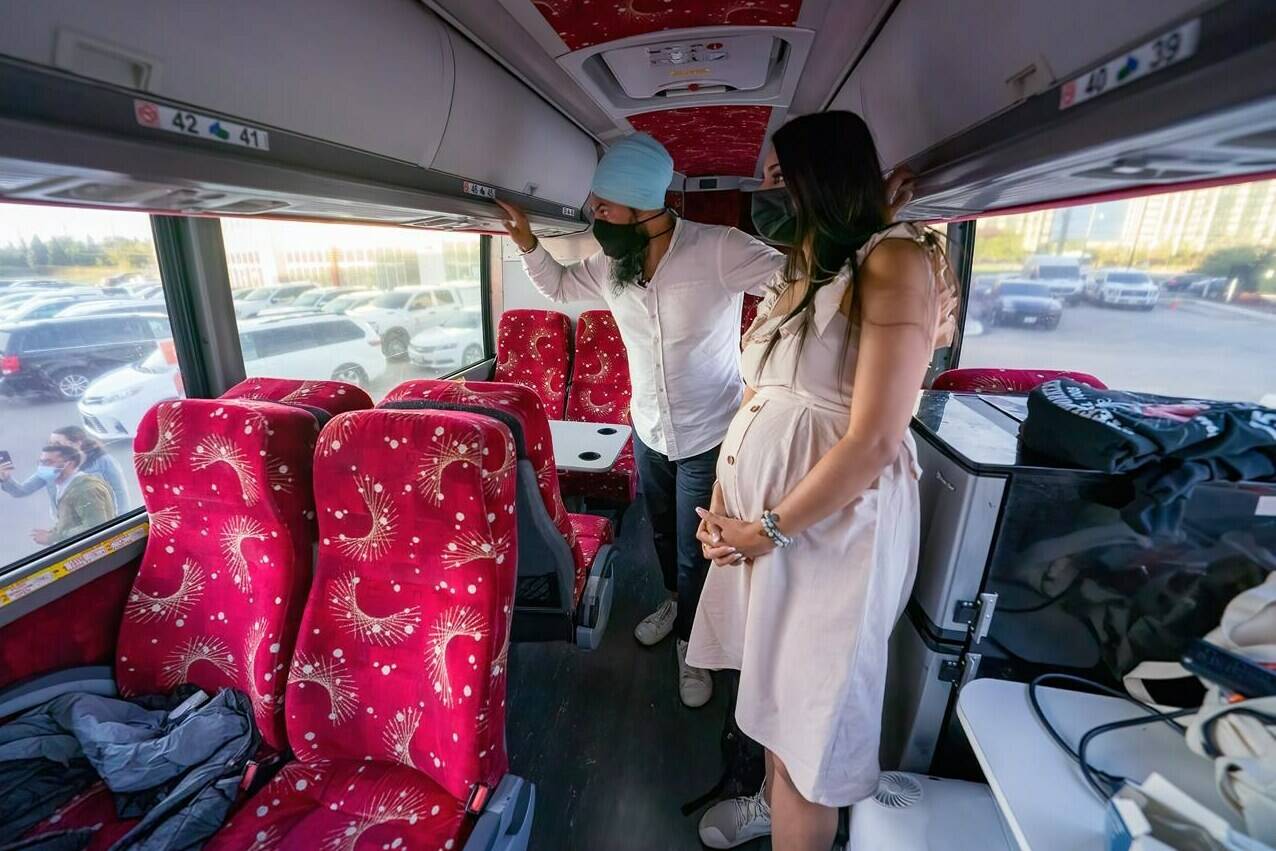 NDP Leader Jagmeet Singh and his wife Gurkiran Kaur Sidhu wait on their campaign bus to be introduced to a crowd at a campaign stop in Brampton, Ont. Wednesday, Sept. 15, 2021. THE CANADIAN PRESS/Jonathan Hayward
