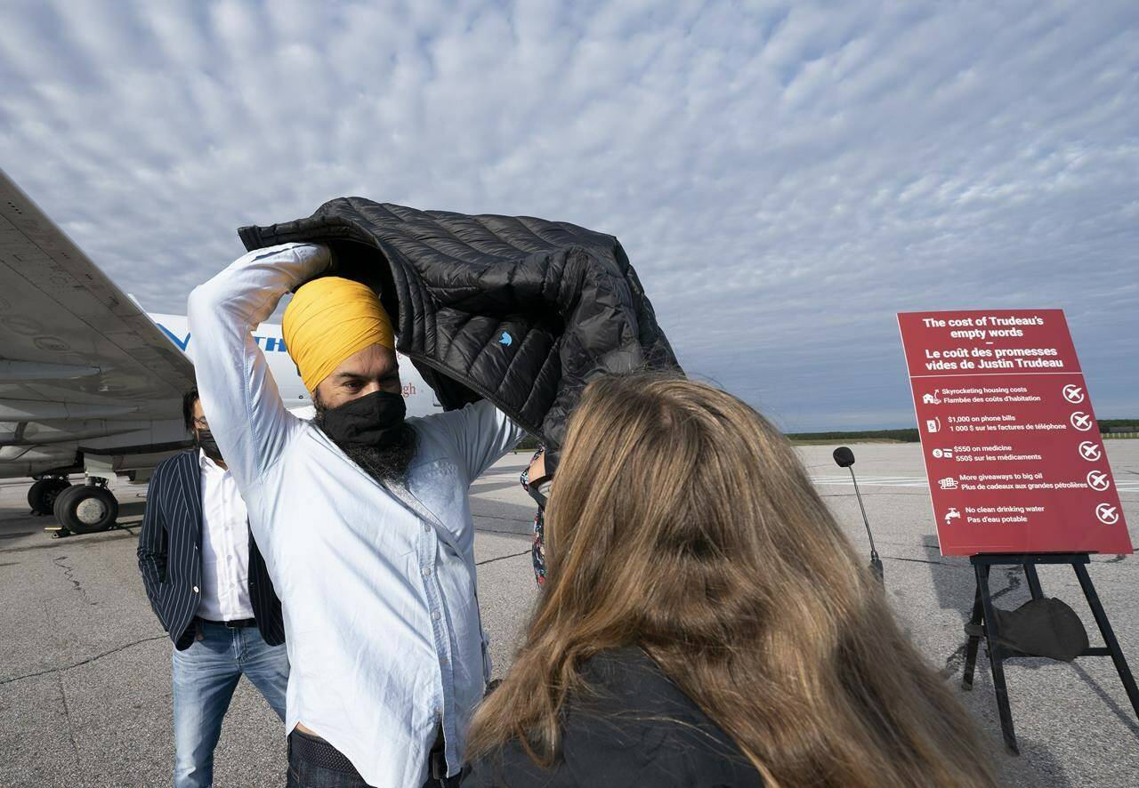 NDP leader Jagmeet Singh puts on his jacket following a morning announcement in Sioux Lookout, Ont., Monday, September 13, 2021. THE CANADIAN PRESS/Jonathan Hayward