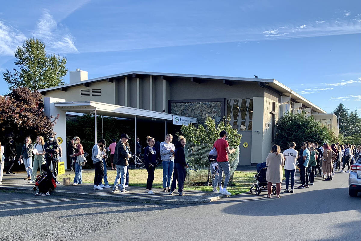 Voters line the block outside of the polling station at Broad View United in Saanich. (Megan Atkins-Baker/News Staff)