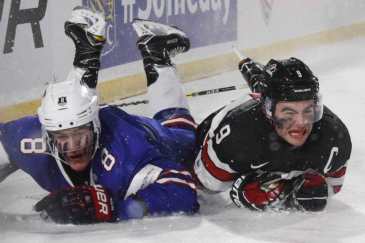 Canada’s Dillon Dube, right, and the United States’ Adam Fox collide during third period IIHF World Junior Championship preliminary outdoor game action at New Era Field in Orchard Park, N.Y. on Friday. (THE CANADIAN PRESS)
