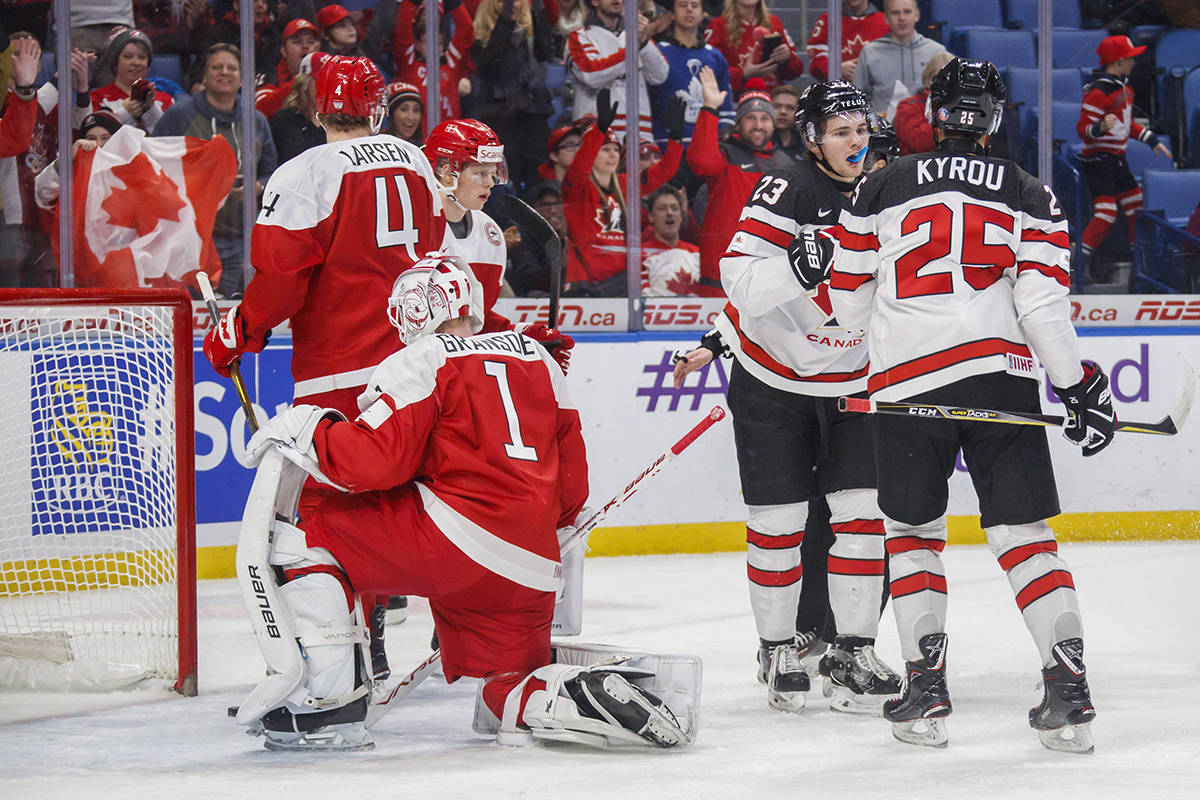 Canada’s Sam Steel (23) celebrates his goal with teammate Jordan Kyrou (25) against Denmark’s Emil Gransoe (1) and Christian Larsen (4) during first period IIHF World Junior Championship preliminary action in Buffalo, N.Y., on Saturday. THE CANADIAN PRESS