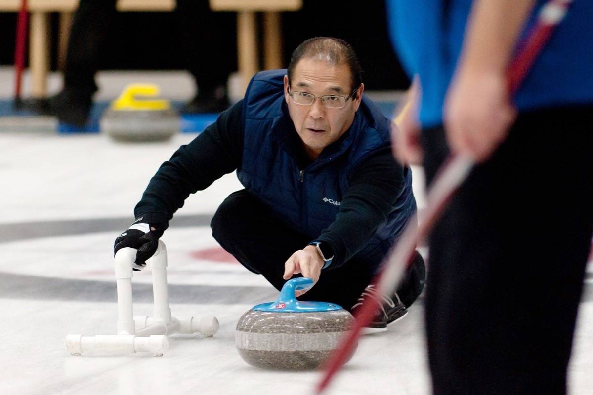 David Sakai of Parksville releases a shot during the B final of the annual Parksville Curling Club Men’s Open Bonspiel in Parksville Sunday, Dec. 3, 2017. Sakai’s rink topped Duncan’s Keith Ainsley for the B title. — J.R. Rardon photo