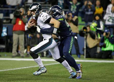 Seattle Seahawks defensive end Frank Clark, right, sacks Philadelphia Eagles quarterback Carson Wentz (11) in the second half of an NFL football game Sunday, Dec. 3, 2017, in Seattle. The Seahawks won 24-10. (AP Photo/Ted S. Warren)