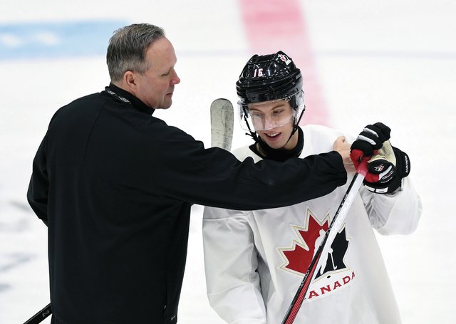Former Victoria Royals and Team Canada head coach Dave Lowry jokes around with national team member Mitch Marner during practise at a previous IIHF World Junior Championship. Full-event ticket packages are on sale now for the 2019 event being played in Victoria and Vancouver in December and January 2018-19. THE CANADIAN PRESS/Sean Kilpatrick