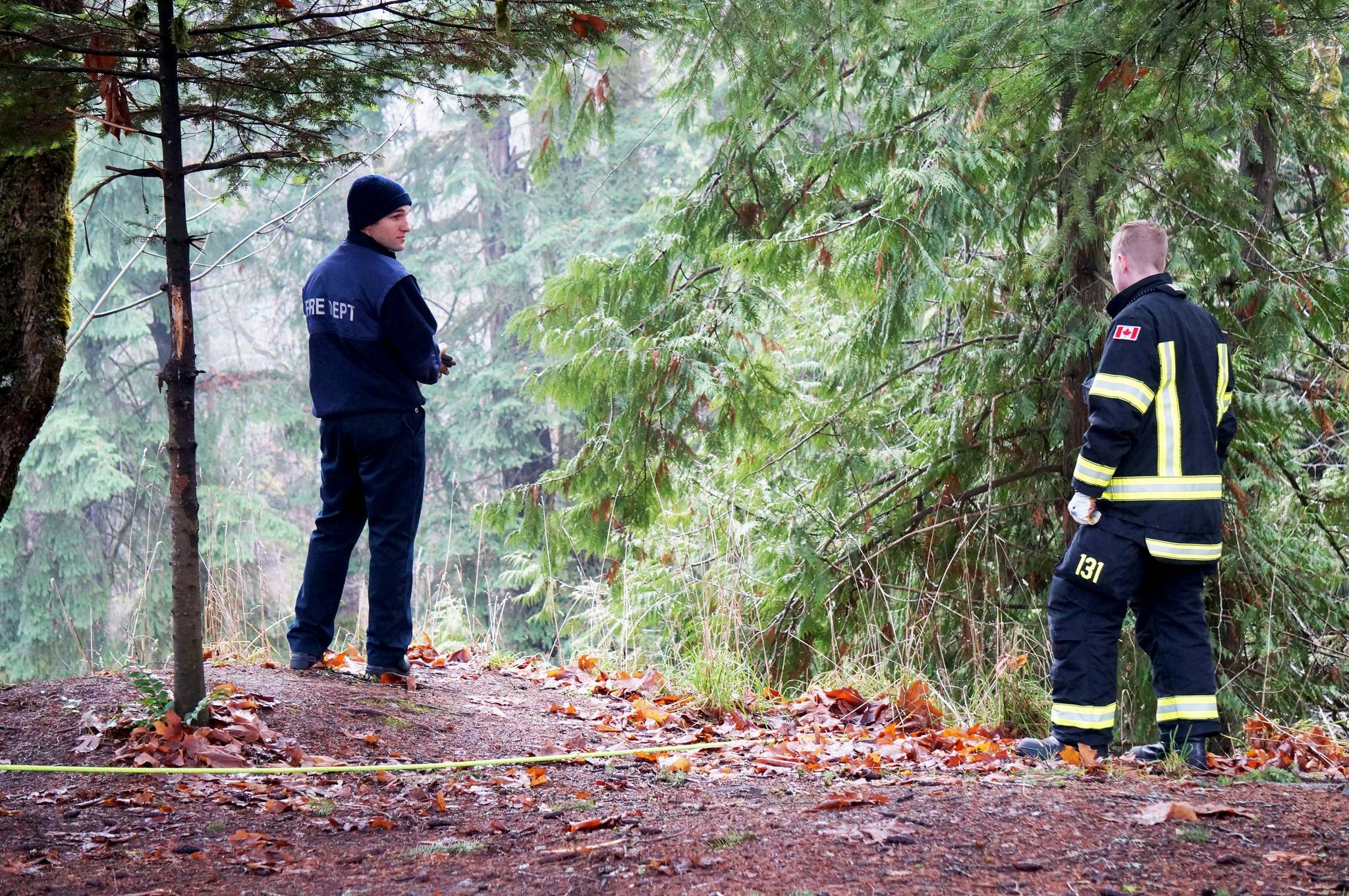 Emergency crews prepare to pull up a person that fell down an embankment at Roger Creek on Tuesday, Dec. 12. KARLY BLATS PHOTO