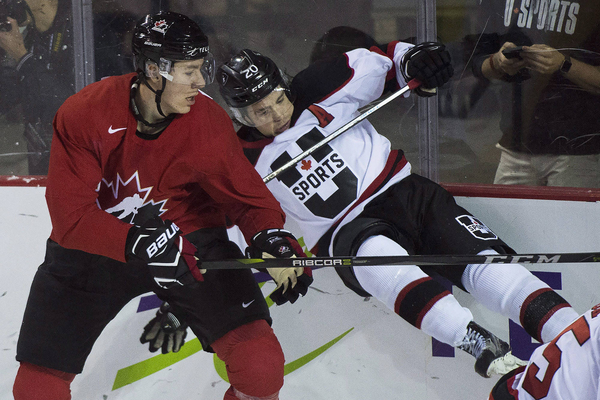 Canada’s Logan Stanley (7) hits USports’ Brett Welychka (20) during first period exhibition hockey action in preparation for the upcoming IIHF World Junior Championships in St. Catharines, Ont., on Thursday. Stanley was one of six players cut from the selection camp roster on Thursday. (THE CANADIAN PRESS)