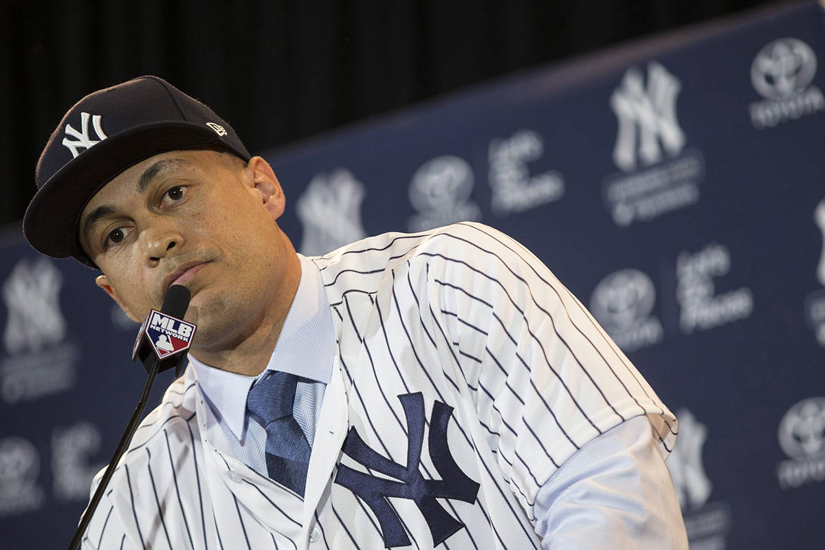 New Yankee Giancarlo Stanton answers questions during a press conference at the Major League Baseball winter meetings in Orlando, Fla., Monday, Dec. 11, 2017. (AP Photo)