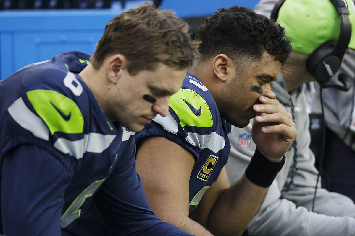 Seattle Seahawks quarterback Russell Wilson, right, and backup quarterback Austin Davis, left, sit on the bench during the second half of an NFL football game against the Los Angeles Rams, Sunday, Dec. 17, 2017, in Seattle. (AP Photo/Elaine Thompson)