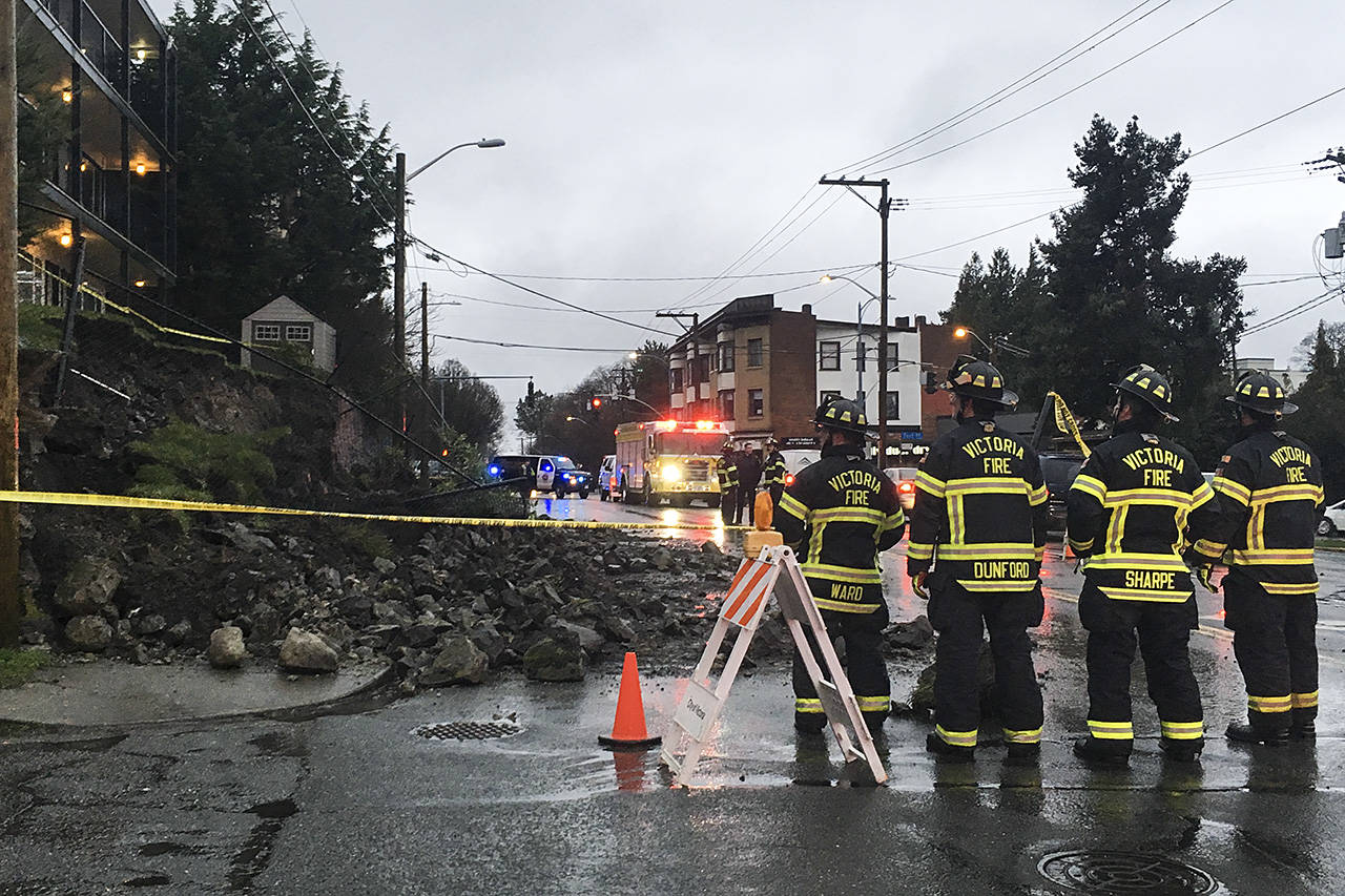Victoria firefighters look at the rubble on the scene after a retaining wall collapsed near the corner Oak Bay Ave. and Fort St. Tuesday morning. (Lauren Boothby/VICTORIA NEWS)