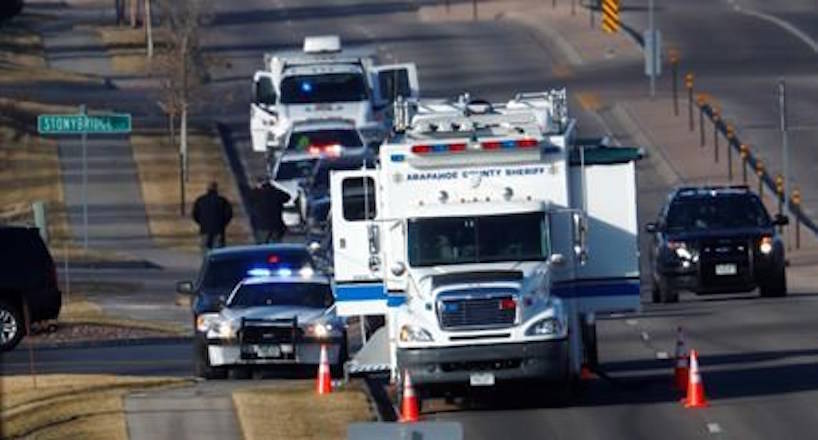 An investigator heads to the scene of shooting Sunday, Dec. 31, 2017, in Highlands Ranch, Colo. Authorities in Colorado say one deputy has died and multiple others were wounded, along with two civilians, in a shooting that followed a domestic disturbance in suburban Denver. (AP Photo/David Zalubowski)