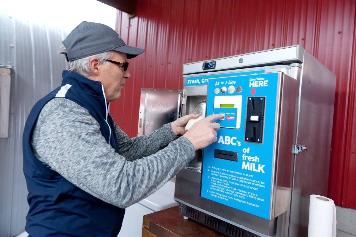 Bill Flower of Parksville tries out the new milk dispenser at Parksville’s Morningstar Farm during his first visit to the farm Wednesday, Jan. 3, 2018. — J.R. Rardon photo