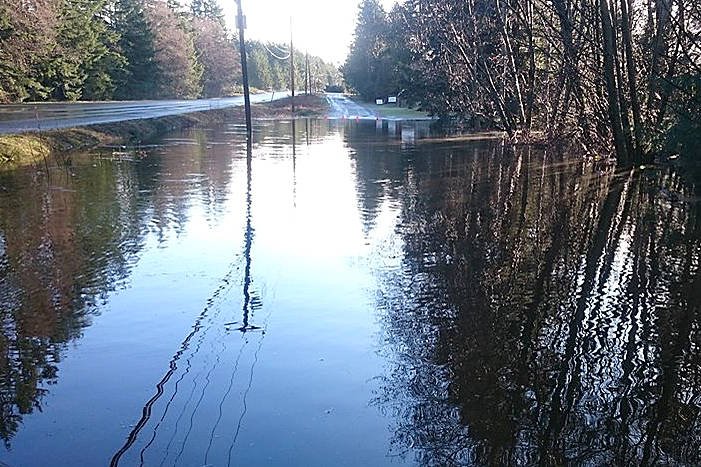 Poplar Road, which parallels Highway 4 west of Qualicum Beach (at left), has been closed after being inundated by floodwaters Sunday morning, Jan. 21, 2018. — Image from Coombs-Hilliers Volunteer Fire Department Facebook page