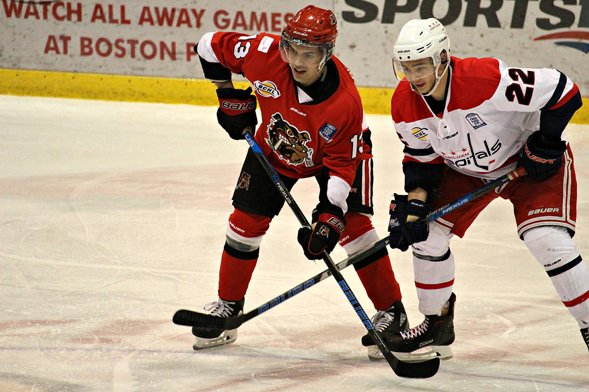Bulldogs forward, Christian Simeone and Cowichan Capitals forward, Azzaro Tingling, square off at center circle in the second period. KAICEE TROTT PHOTO