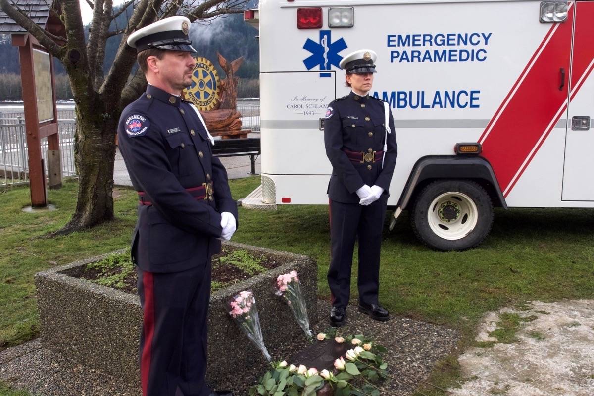 BC Ambulance Service honour guards Lonnie Barkhouse of Chilliwack, left, and Rosalene Berg of Abbotsford stand guard at Schlamp’s memorial plaque. Barry Stewart photo