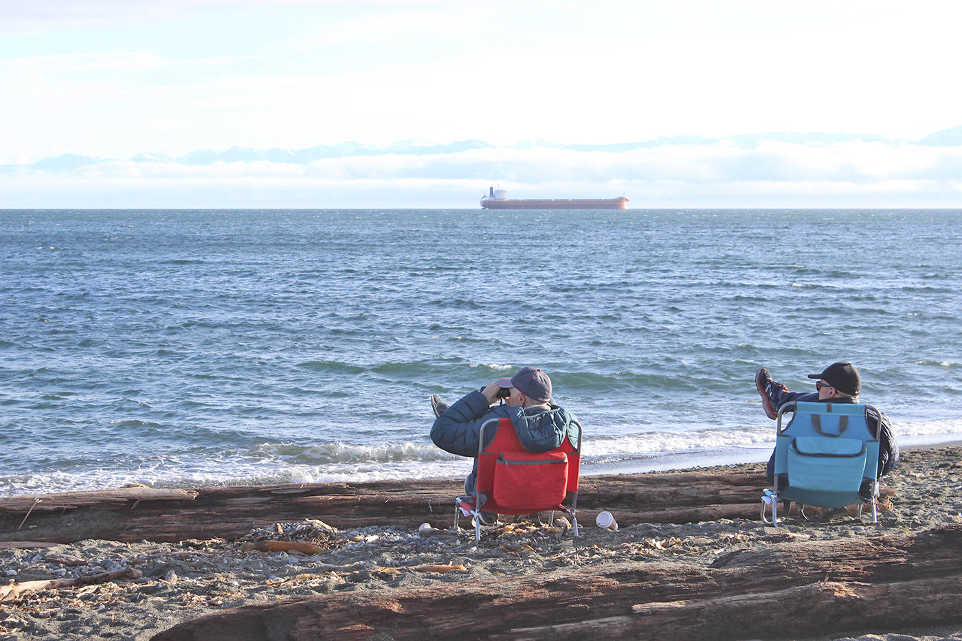 WINDY SUNDAY                                Many people, including these two men, enjoy the waves at Esquimalt Lagoon on a windy Sunday afternoon. (Kendra Wong/News Gazette staff)
