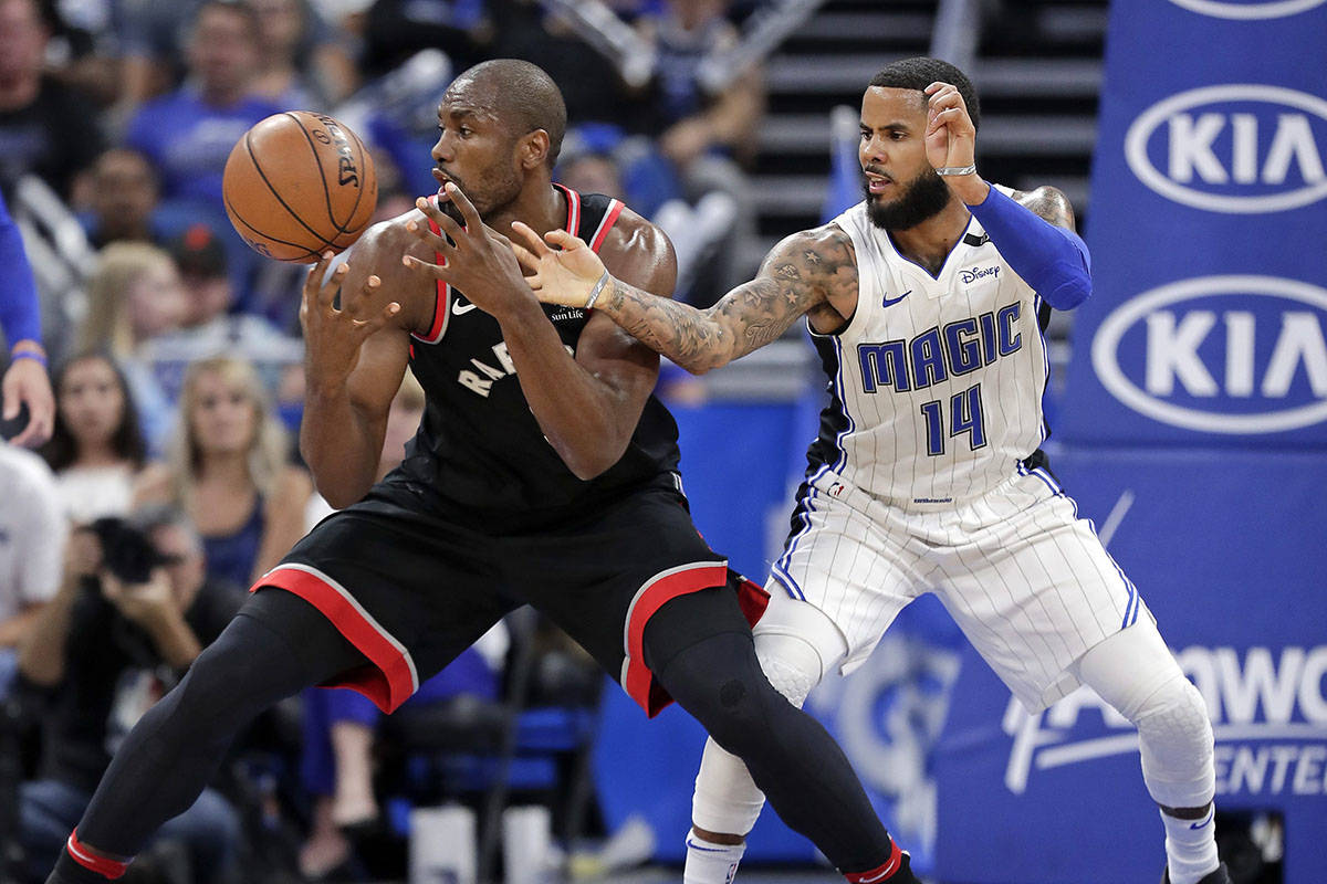 Toronto Raptors&rsquo; Serge Ibaka, left, loses his grip on the ball for amount as he Orlando Magic&rsquo;s D.J. Augustin (14) defends during the second half of an NBA basketball game Wednesday, Feb. 28, 2018, in Orlando, Fla. Toronto won 117-104. (AP Photo/John Raoux)