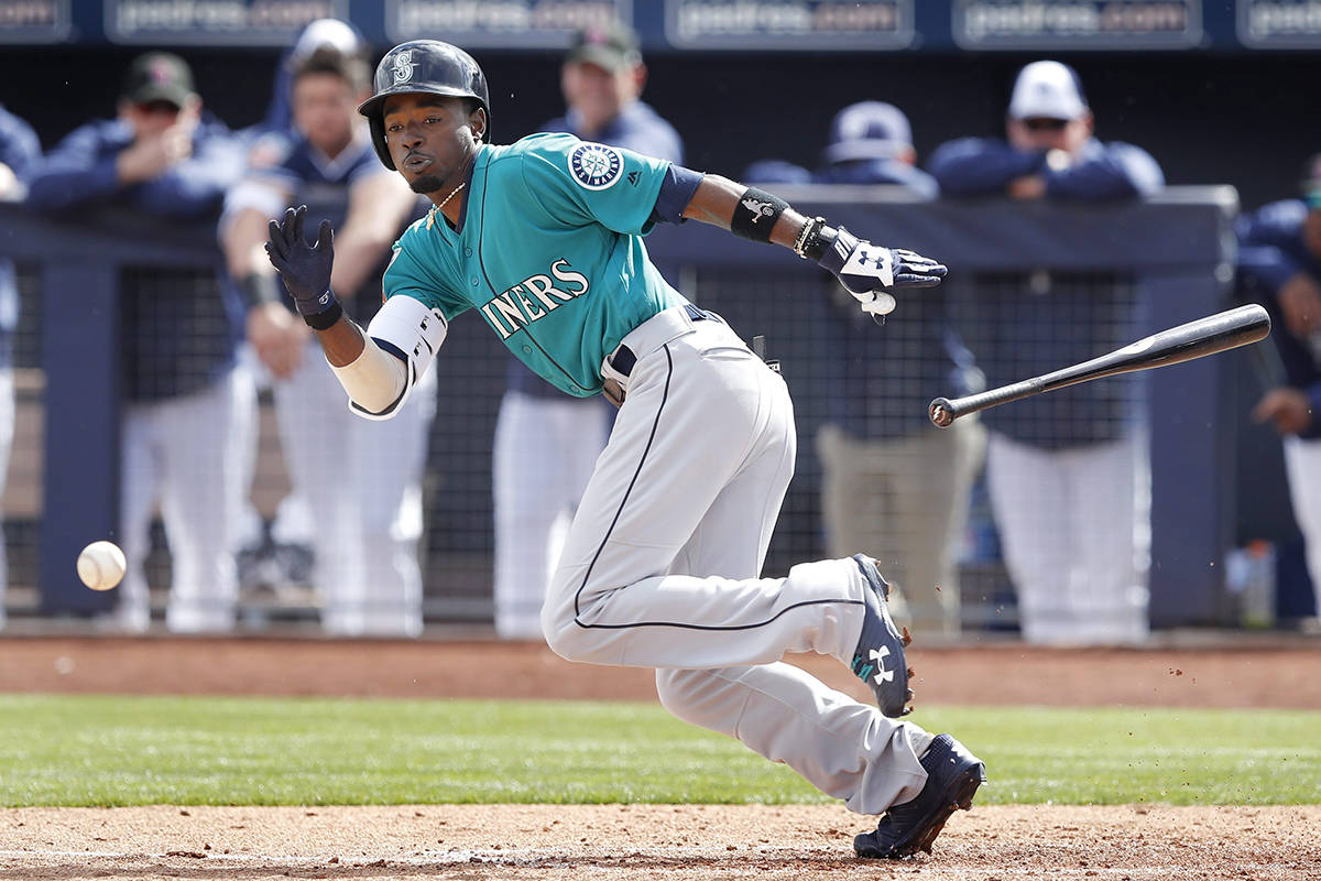 Seattle Mariners’ Dee Gordon bunts during the second inning of a baseball spring exhibition game against the San Diego Padres, Friday, Feb. 23, 2018, in Peoria, Ariz. Gordon was out on the play. (AP Photo/Charlie Neibergall)