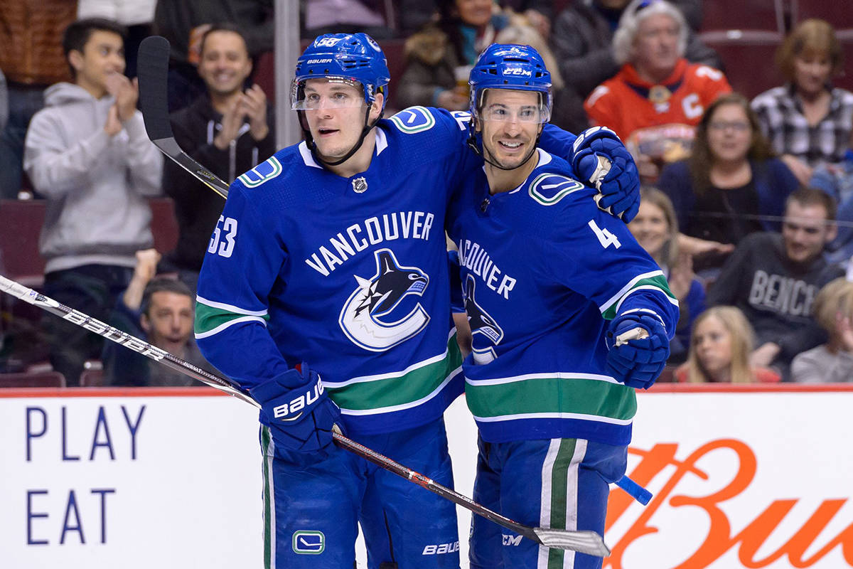 Vancouver Canucks Bo Horvat, left, and Michael Del Zotto celebrate a first-period goal during NHL action against the Nashville Predators Friday at Rogers Arena. (via @Canucks/Twitter)