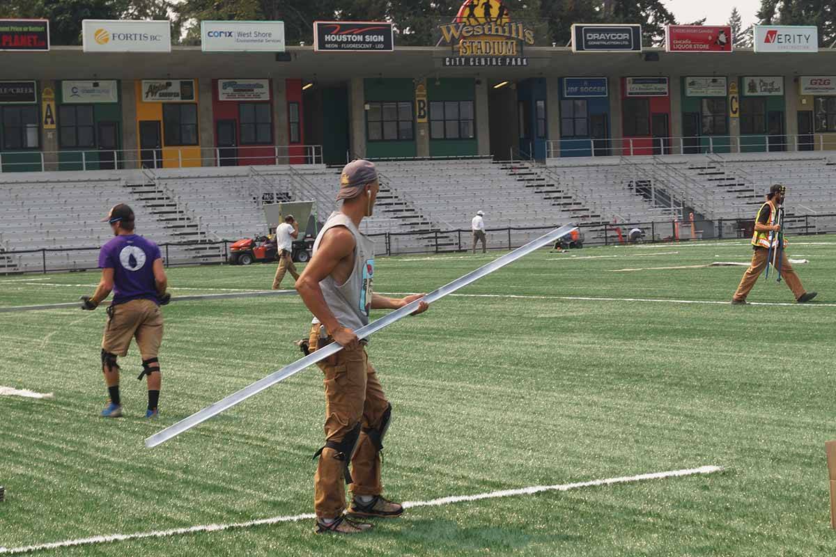Workers instal lines on the turf in Westhills Stadium at City Centre Park. (Gazette file photo)