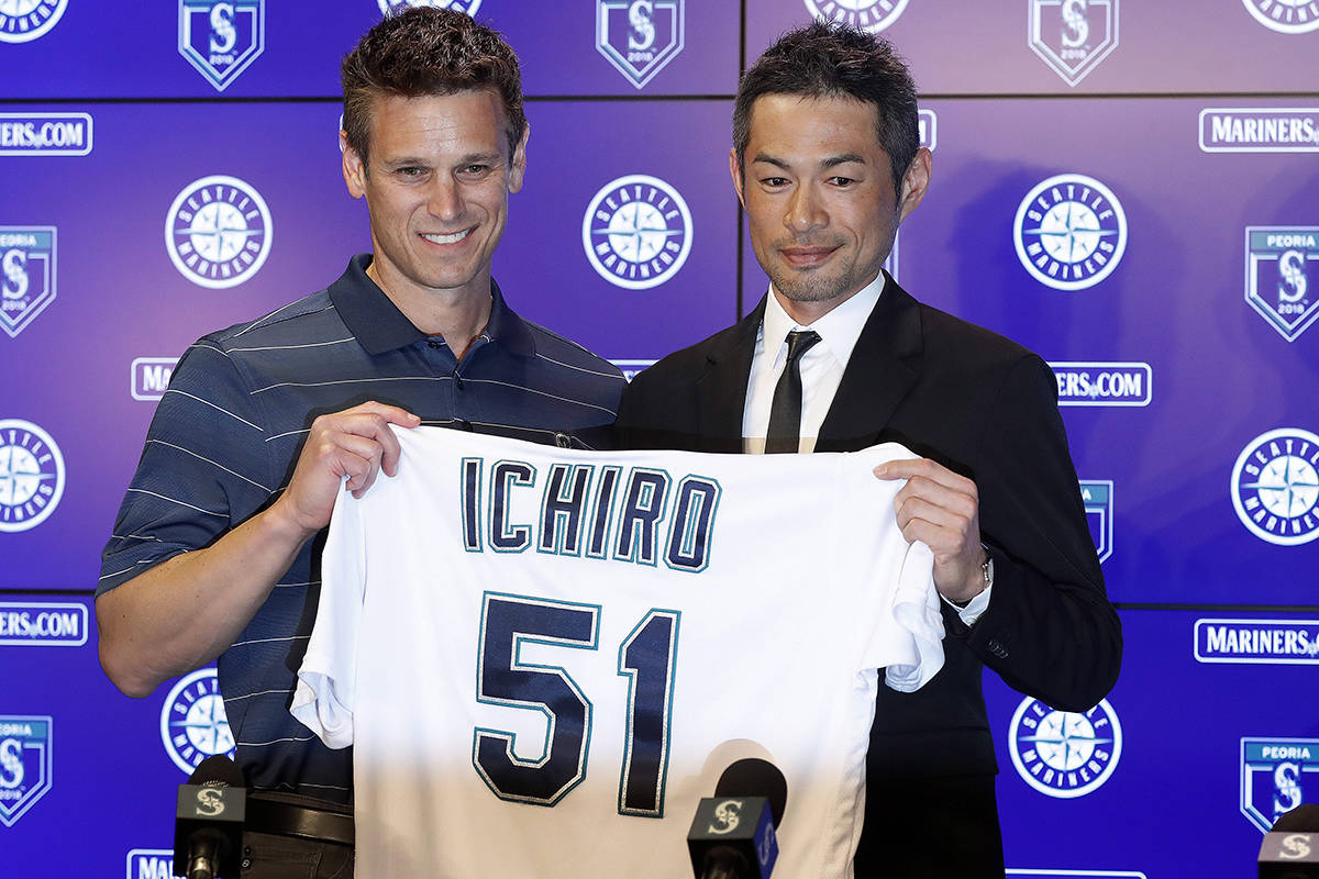 Seattle Mariners’ Ichiro Suzuki, right, holds up his jersey with Mariners general manager Jerry Dipoto during a news conference at the teams’ spring training baseball complex Wednesday, March 7, 2018, in Peoria, Ariz. Suzuki signed a one-year deal with the team. (AP Photo/Matt York)