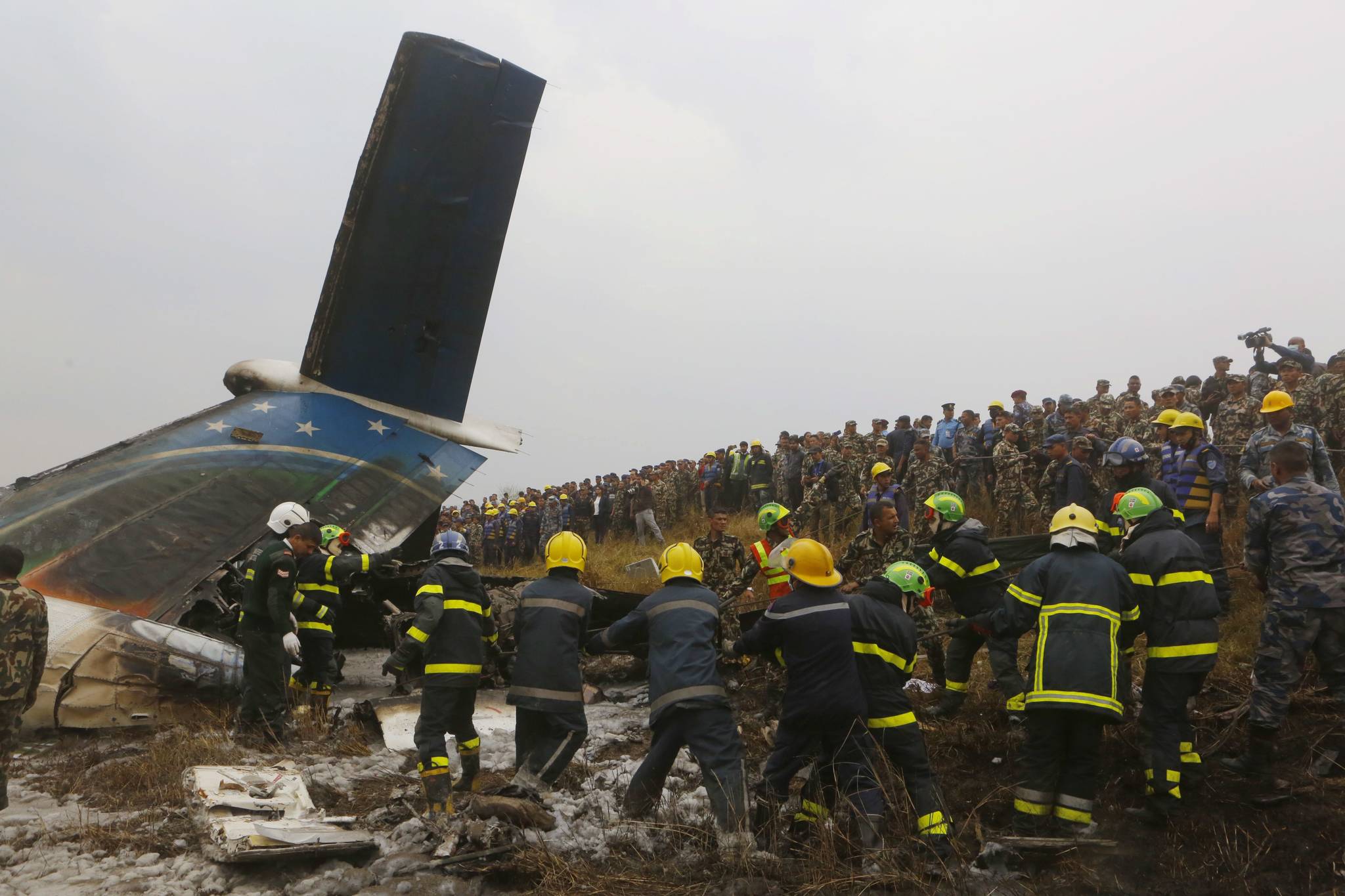 Nepalese rescuers work amid the debris after a passenger plane from Bangladesh crashed at the airport in Kathmandu, Nepal, Monday, March 12, 2018. The passenger plane carrying 71 people from Bangladesh crashed and burst into flames as it landed Monday in Kathmandu, Nepal’s capital, killing dozens of people, officials said. (AP Photo/Niranjan Shreshta)
