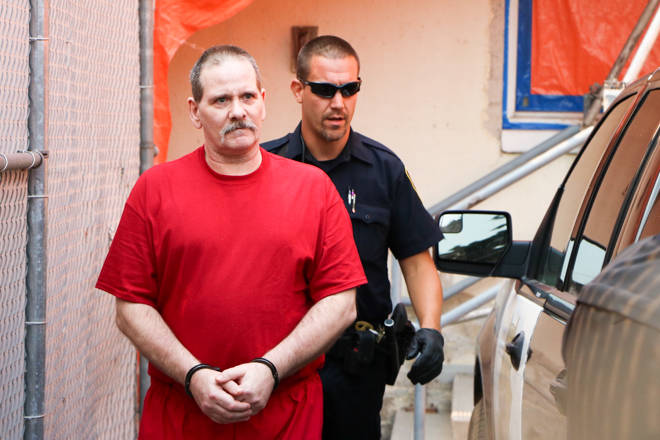 Ronald Teneycke is escorted out of Penticton’s courthouse during the summer, following hearings on a Crown application for a dangerous offender application for the notorious South Okanagan criminal.                                Dustin Godfrey/Western News