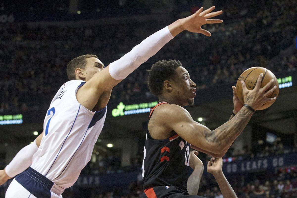 Toronto Raptors guard DeMar DeRozan (10) shoots past Dallas Mavericks centre Dwight Powell (7) during first half NBA basketball action in Toronto on Friday March 16, 2018. THE CANADIAN PRESS/Chris Young