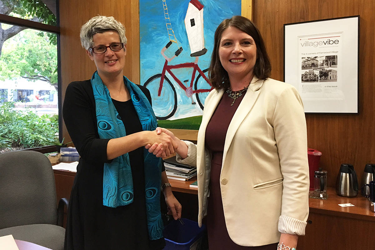 Mayor Lisa Helps shakes the hand of Christine Gleed, the chair of the board of the YMCA/YWCA Vancouver Island, upon signing a Memorandum of Understanding, formalizing their joint commitment to the planning of services and programs for the citizens of Greater Victoria. Kristyn Anthony/VICTORIA NEWS