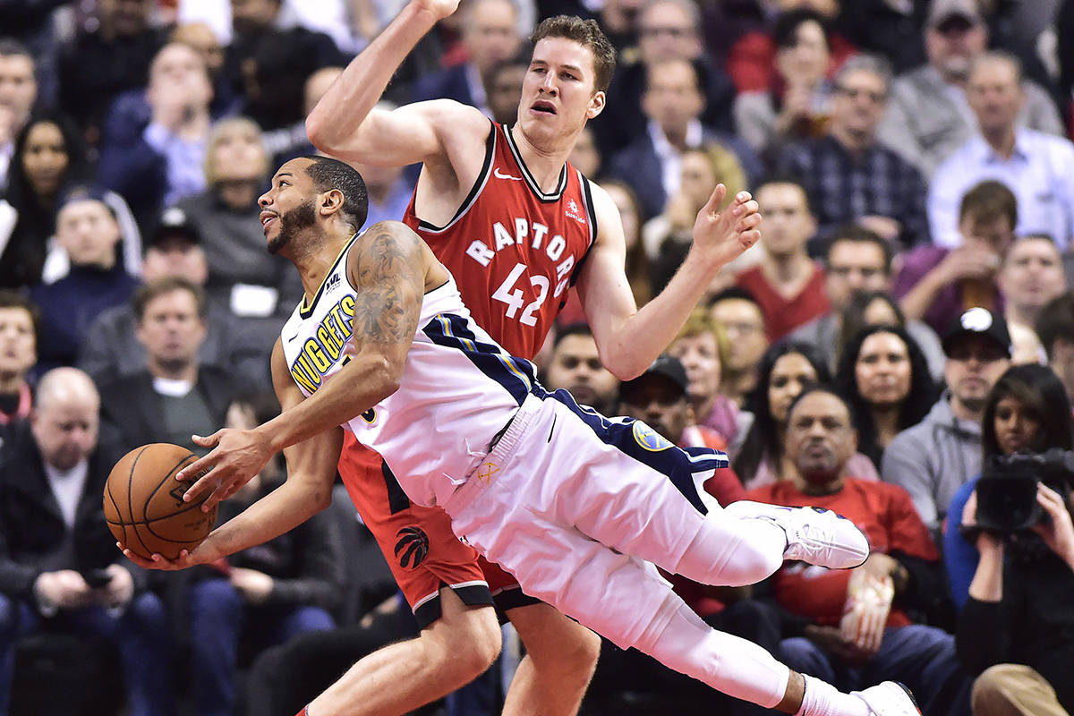 Denver Nuggets guard Devin Harris (34) falls as Toronto Raptors centre Jakob Poeltl (42) defends during first half NBA basketball action in Toronto on Tuesday, March 27, 2018. THE CANADIAN PRESS/Frank Gunn