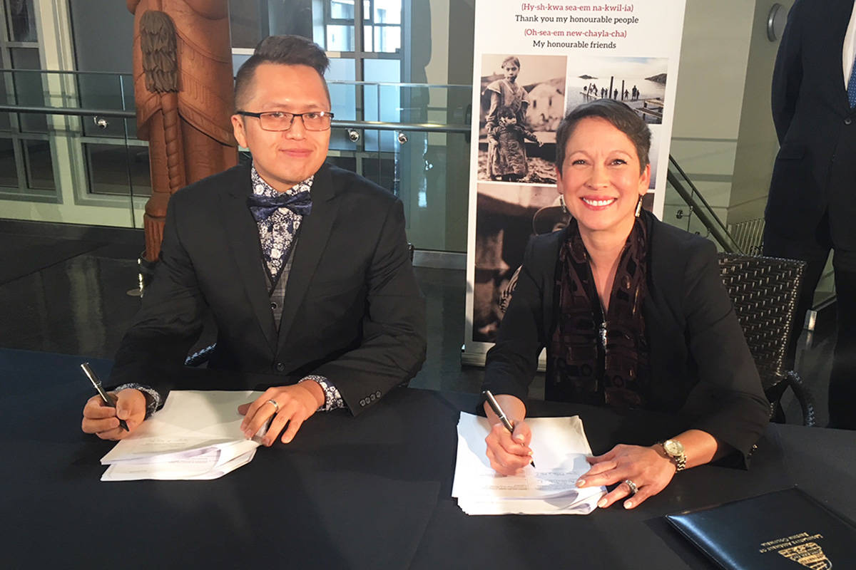 Songhees Nation councillor Gary Sam joins Minister of Advanced Education, Skills and Training, Melanie Mark, to sign an agreement securing $655,000 in funding to launch a culinary, hospitality and tourism program on Songhees Nation, in partnership with Camosun College. Kristyn Anthony/VICTORIA NEWS
