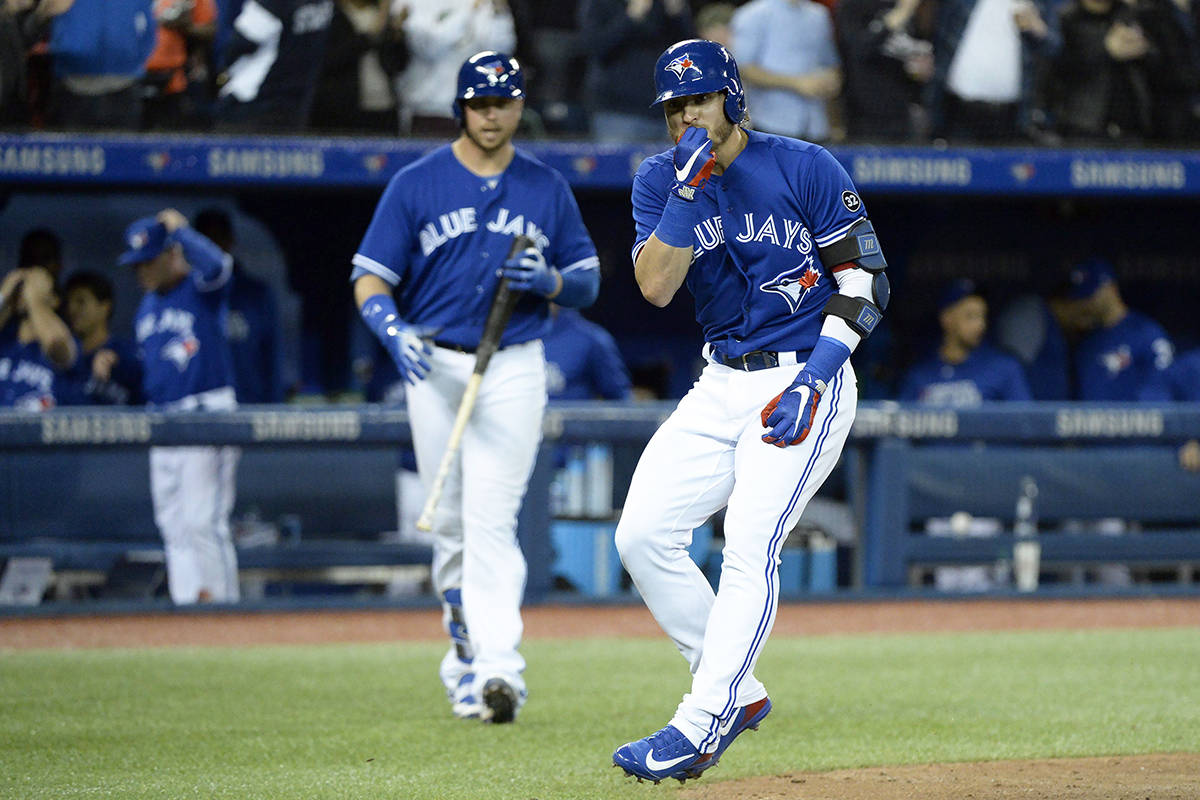 Toronto Blue Jays third baseman Josh Donaldson (20) gestures to the Chicago White Sox dugout after his solo home run during sixth inning American League baseball action in Toronto on Monday, April 2, 2018. THE CANADIAN PRESS/Nathan Denette