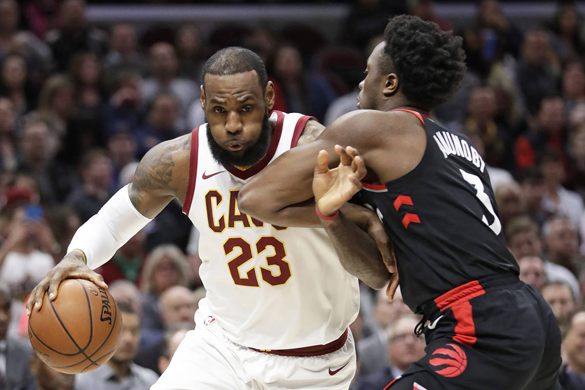 Cleveland Cavaliers’ LeBron James, left, drives past Toronto Raptors’ OG Anunoby during the first half of an NBA basketball game Tuesday, April 3, 2018, in Cleveland. (AP Photo/Tony Dejak)