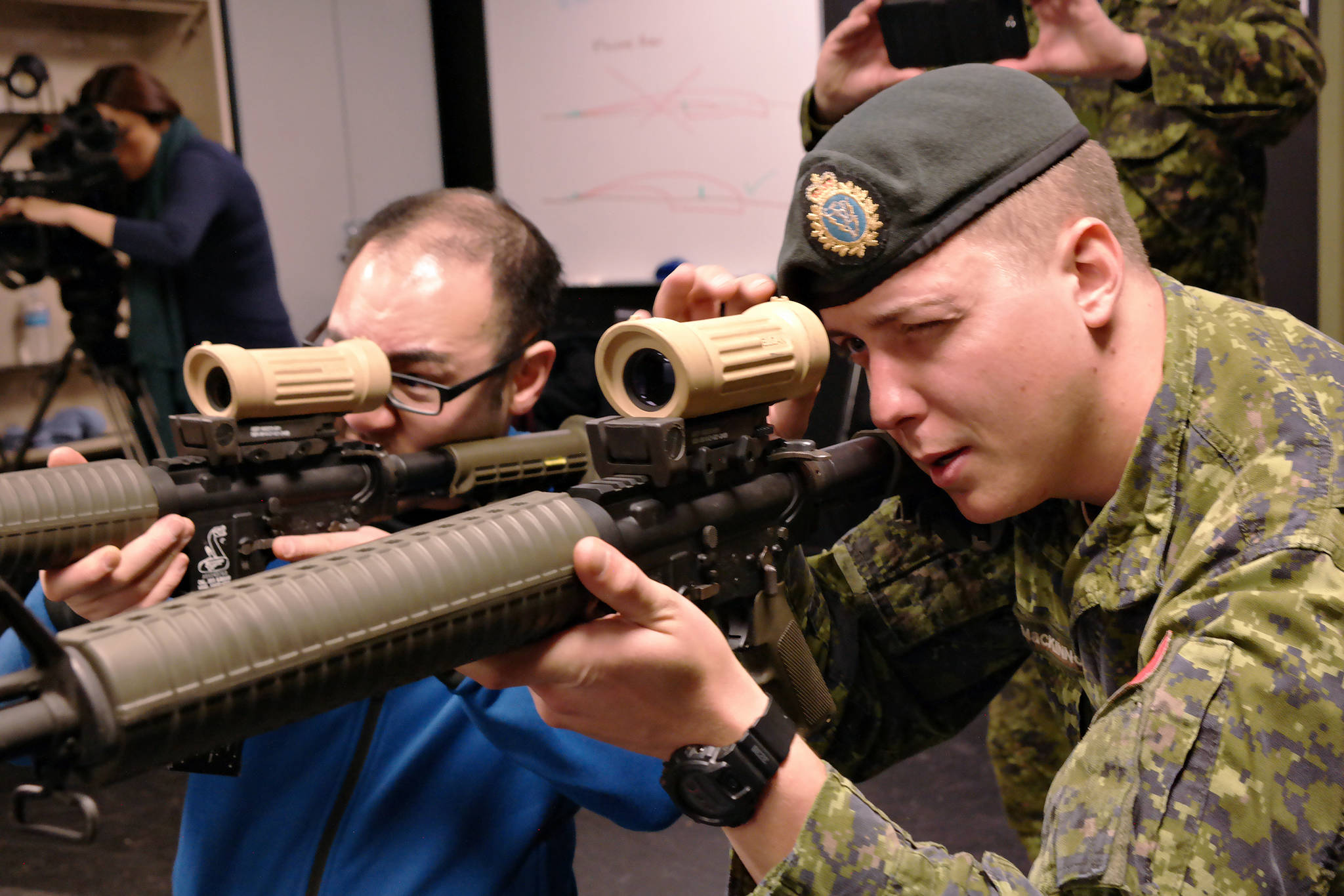 Rangefinders Karl Yu, News Bulletin reporter, receives instruction on how to sight a C-7 rifle from Cpl. Tanner McKinnon at Nanaimo Military Camp’s electronic shooting rang Wednesday. The simulation range arms training is part of an array of activities that will require physical fitness, a keen eye and a taste for ready to eat field rations for visitors attending Soldier For a Day, a public relations event to be hosted by the Canadian Armed Forces at the base Saturday (April 7). (CHRIS BUSH/The News Bulletin)