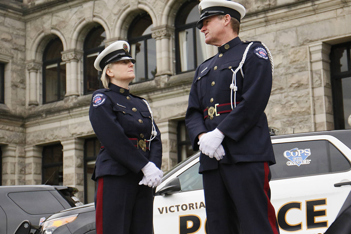 Sandy Ranger, a paramedic in Parksville stands with Bruce Honeyman, advanced care paramedic in Victoria, on the steps of the legislature Wednesday, where Minister Harry Bains announced amendments to legislation that would eliminate barriers for first responders to access compensation for mental trauma. Kristyn Anthony/VICTORIA NEWS