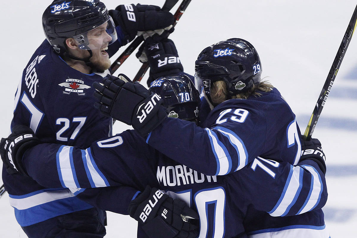 Winnipeg Jets’ Nikolaj Ehlers (27), Joe Morrow (70) and Patrik Laine (29) celebrate Morrow’s game winning goal against the Minnesota Wild during third period NHL game one playoff action in Winnipeg on Wednesday, April 11, 2018. THE CANADIAN PRESS/John Woods