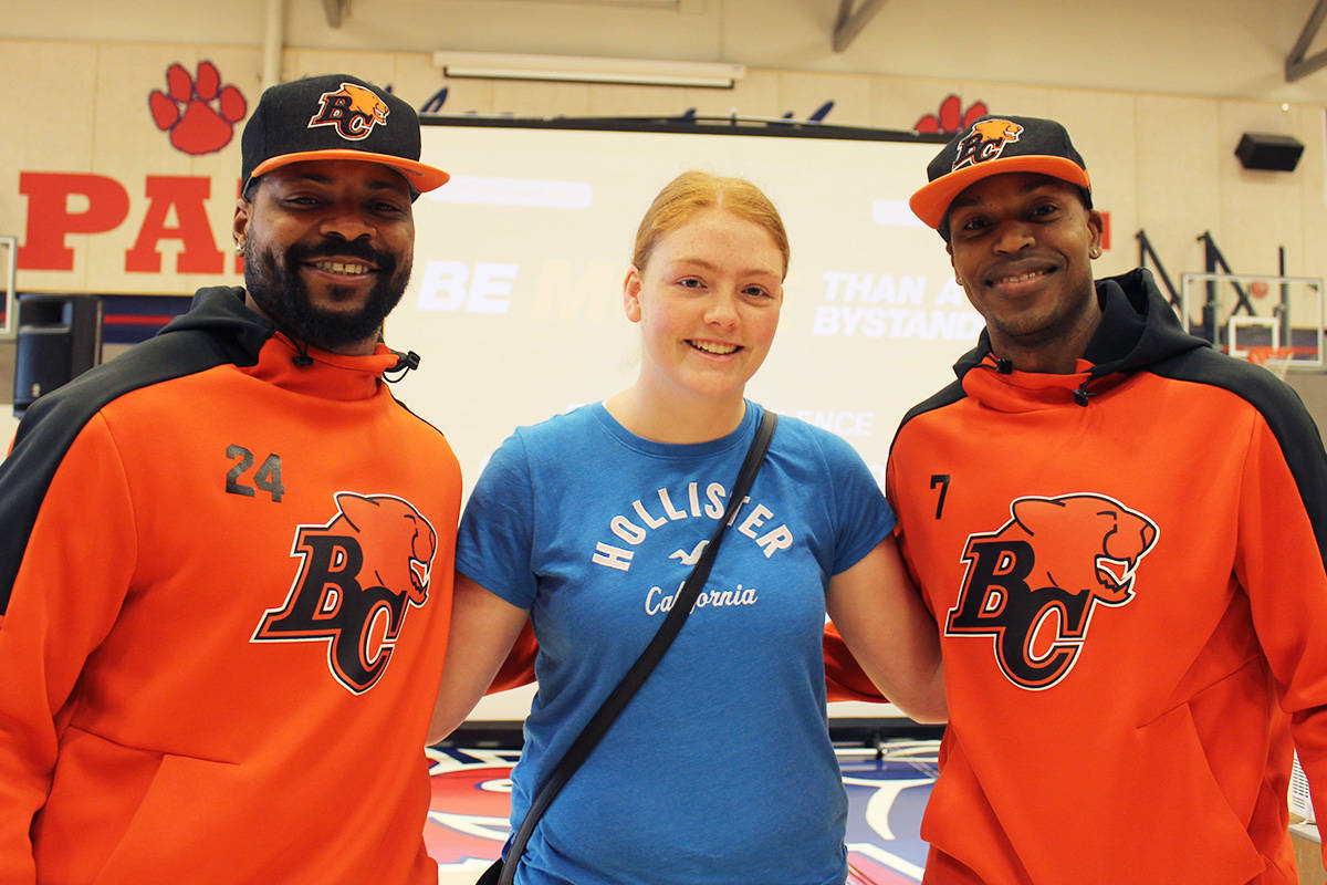 Vernon Secondary School student and grade executive member, Maddy Smith was all smiles when she met BC Lions running back, Jeremiah Johnson and defensive back, Matt Bucknor, before introducing the pair at an assembly held at the school Tuesday morning. Bucknor and Johnson are currently touring the province promoting the Lions’ Be More Than a Bystander program, which promotes ending the silence on violence against women. (Erin Christie/Morning Star)