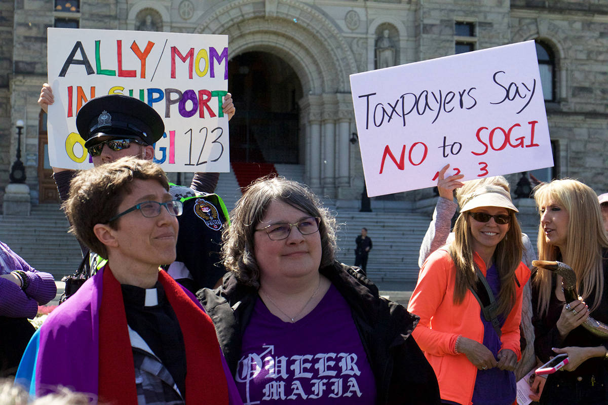 LGBTQ allies and supporters of Sexual Orientation Gender Identity resources that school B.C. districts are using to promote inclusion stand on the legislature lawn with a group of SOGI protesters.                                Kristyn Anthony/VICTORIA NEWS