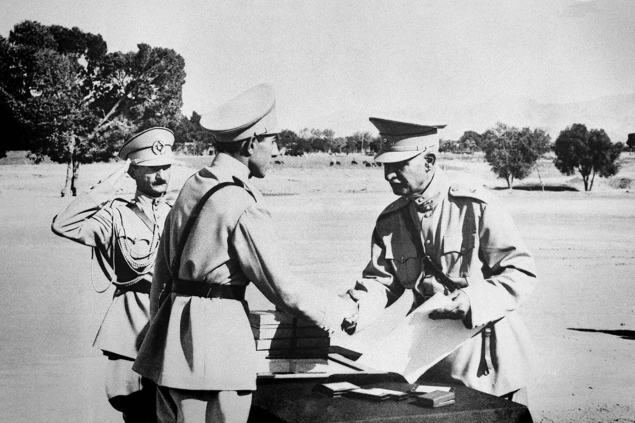 In this August 19, 1941 file photo, Reza Shah Pahlavi, hands second son, Ali Reza, commission as officer at graduation exercises at Iran’s “West Point” in Tehran, Iran prior to Anglo-Russian action. The discovery in Iran of a mummified body near the site of a former royal mausoleum has raised speculation it could be the remains of the late Reza Shah Pahlavi, founder of the Pahlavi dynasty. (AP Photo, File)