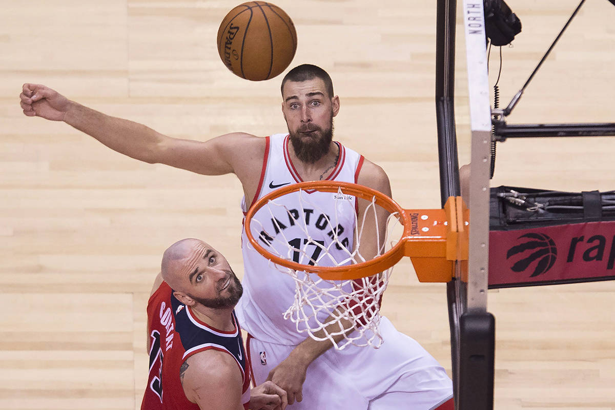Toronto Raptors centre Jonas Valanciunas (17) eyes the ball against Washington Wizards centre Marcin Gortat (13) during second half game five of round one, NBA playoff basketball action in Toronto on Wednesday, April 25, 2018. THE CANADIAN PRESS/Nathan Denette