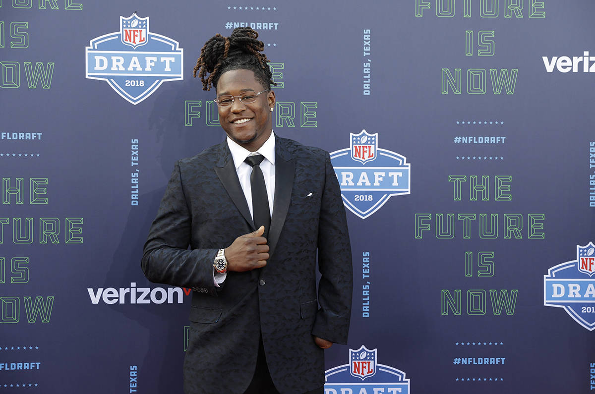 Central Florida’s Shaquem Griffin poses for photos on the red carpet before the first round of the NFL football draft, Thursday, April 26, 2018, in Arlington, Texas. (AP Photo/Eric Gay)