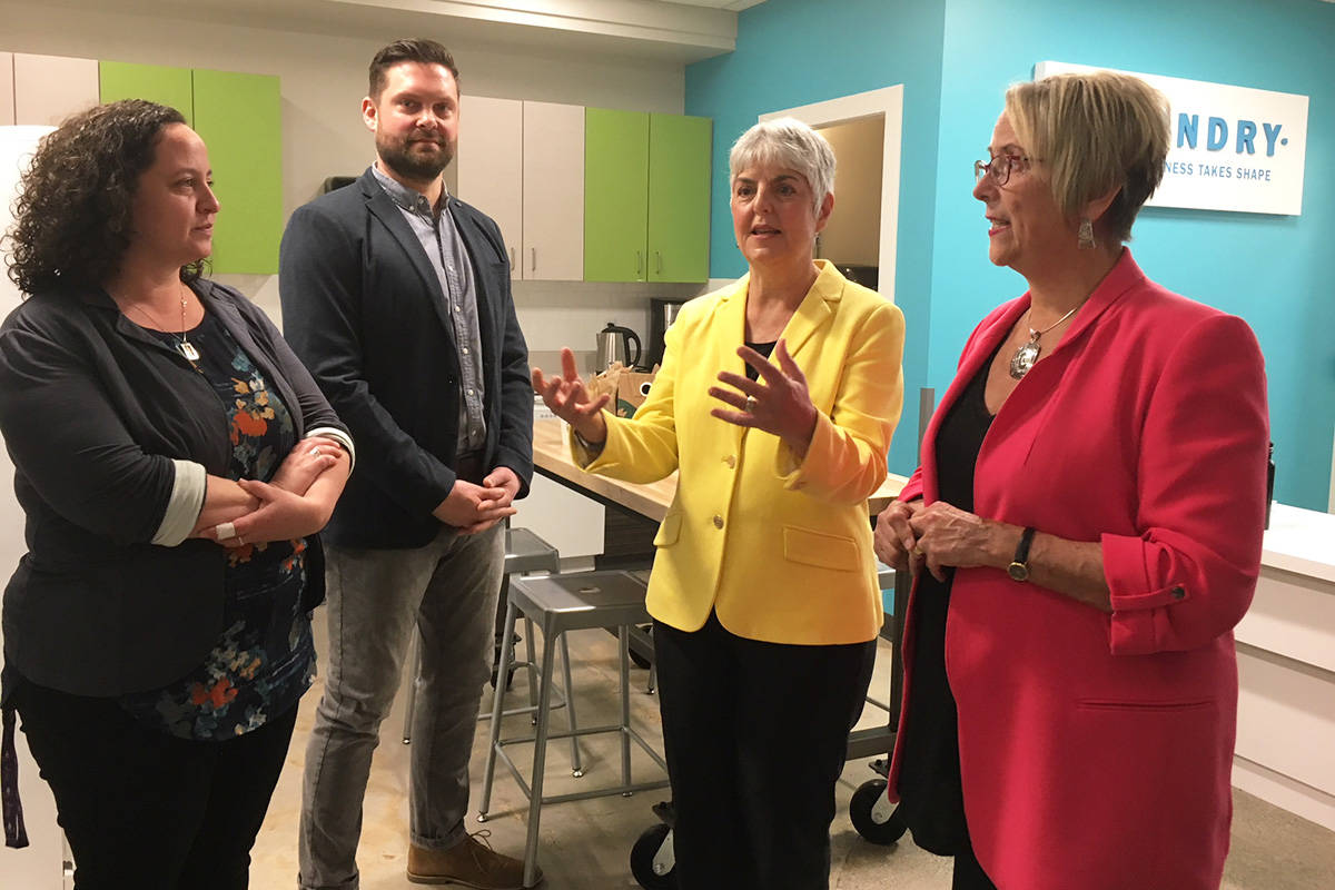 Amy Schactman, clinical co-ordinator at Foundry, joins operations manager Jordan Trousdell as they tour Finance Minister Carole James and Minister of Mental Health and Addictions Judy Darcy through Foundry Victoria, a health and social services centre supporting youth. Kristyn Anthony/VICTORIA NEWS