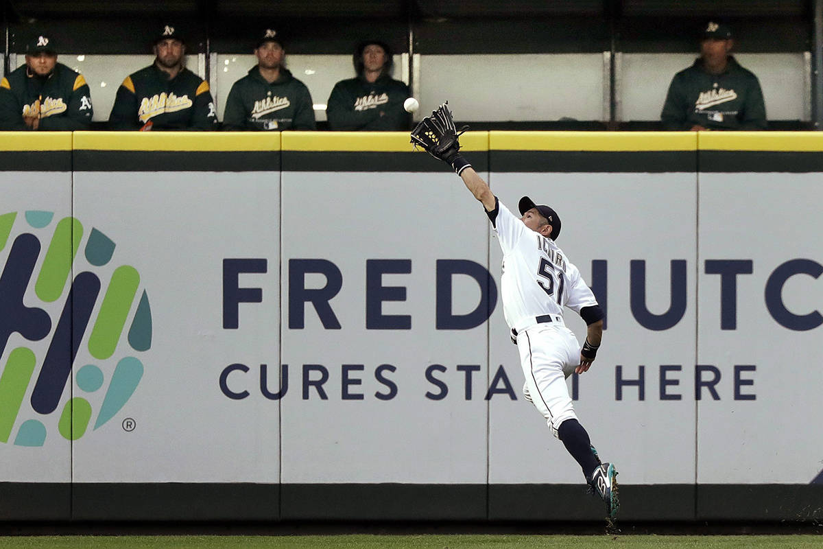 Seattle Mariners right fielder Ichiro Suzuki catches a fly ball from Oakland Athletics’ Matt Chapman during the second inning of a baseball game Wednesday, May 2, 2018, in Seattle. (AP Photo/Elaine Thompson)
