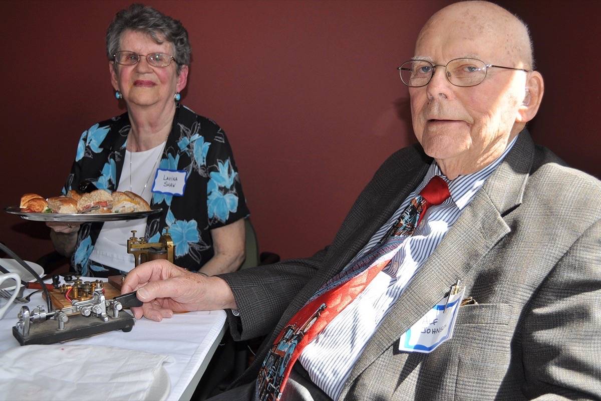 Lavina Shaw, 89, passes the sandwiches after pastor Alfred Johnson, 92, ‘says’ grace by tapping out a prayer in Morse Code. (Photos by Tom Zytaruk)