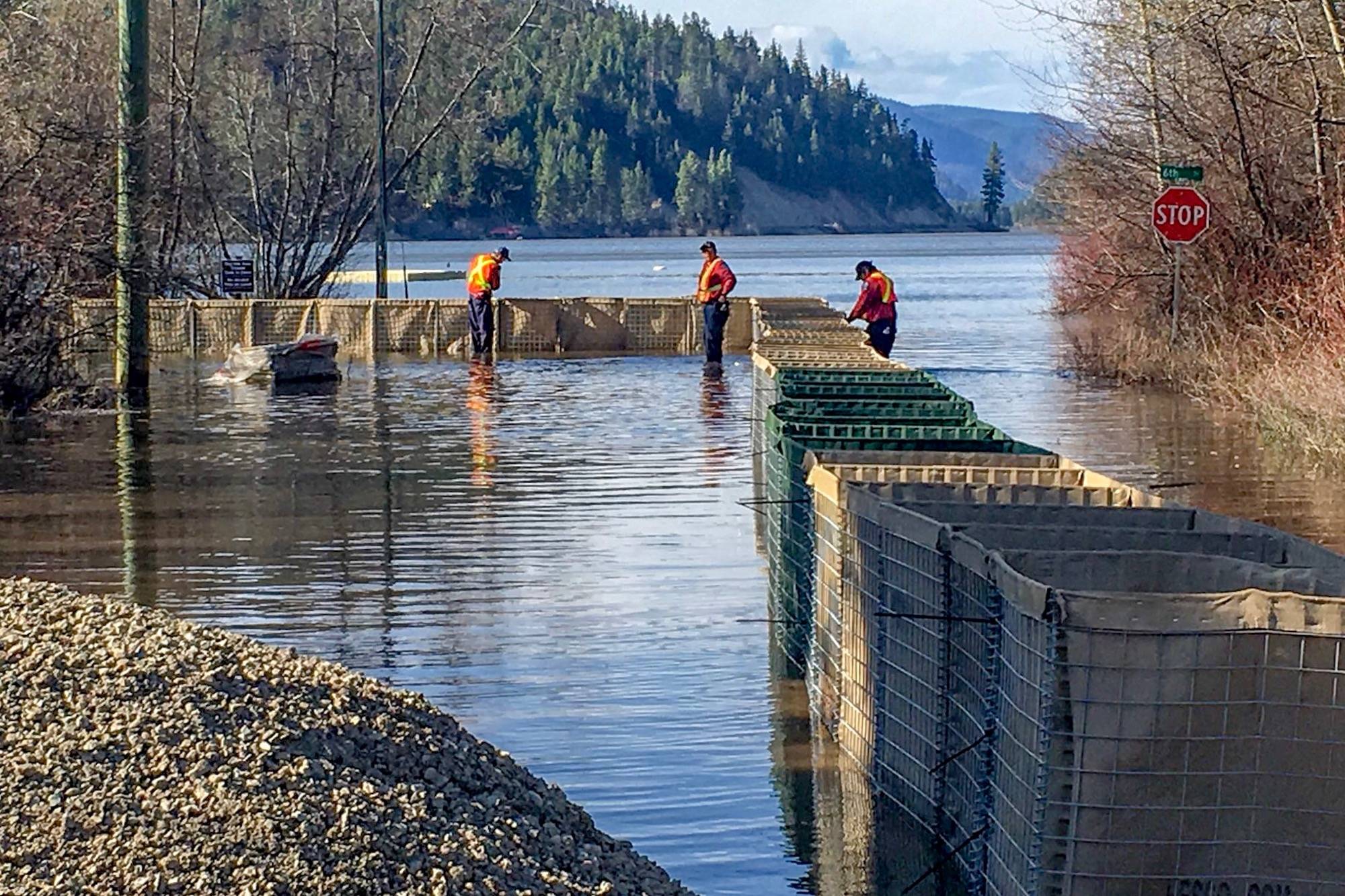 In Tulameen, workers are building gabions, containers filled with gravel, as a temporary dike against rising water in Otter Lake, which has already ignored a stop sign to flood into town. Photo courtesy RDOS